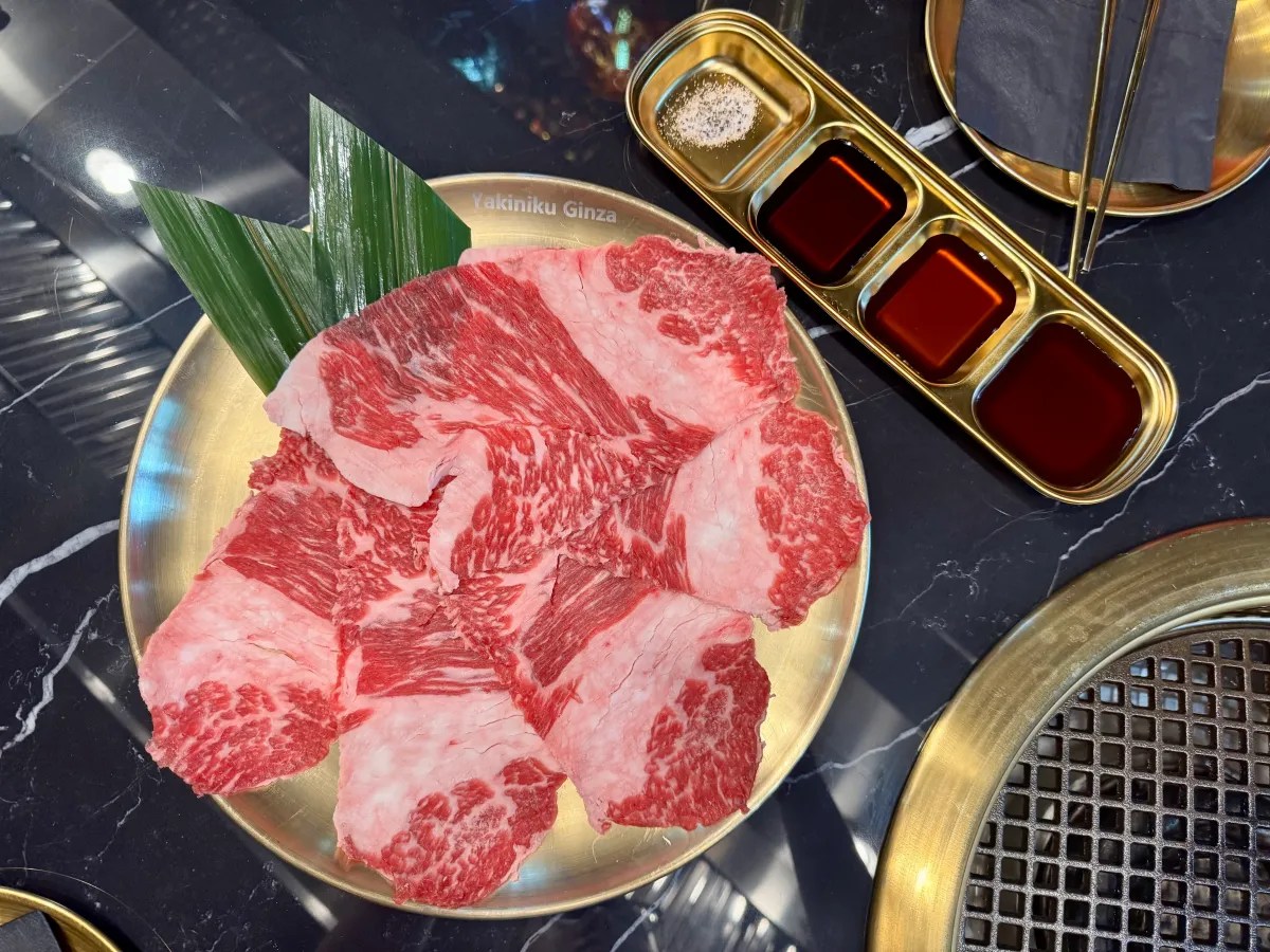 Australian wagyu brisket with a four-compartment sauce tray and tabletop grill.